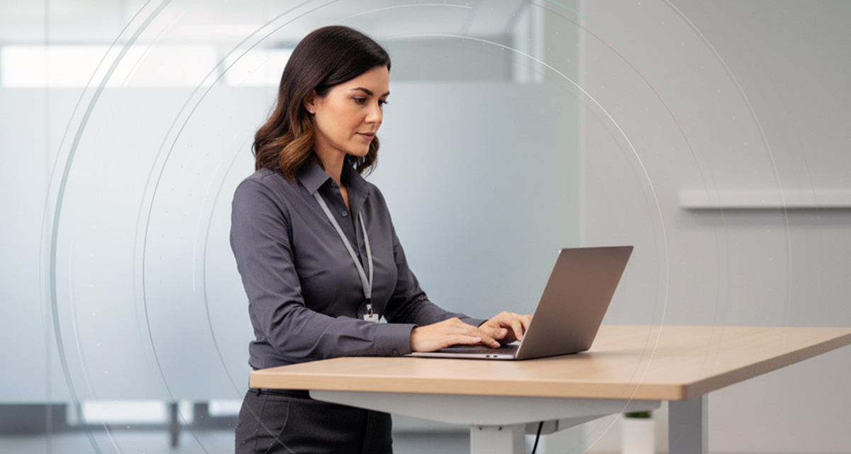 Person working at standing desk using persistent authentication
